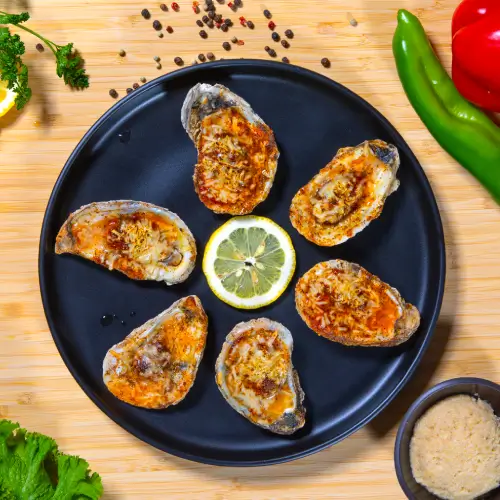 Oysters Rockefeller served at Bayou Brewery in Madison, WI – Fresh oysters with rich spinach, cheese, and garlic sauce.