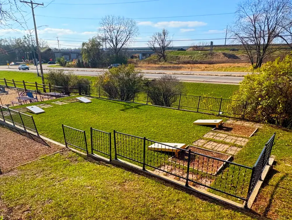 Players enjoying a competitive bean bag toss game at North of the Bayou Brewery in Madison, WI, during the North of the Bayou Bean Bag Toss League event.