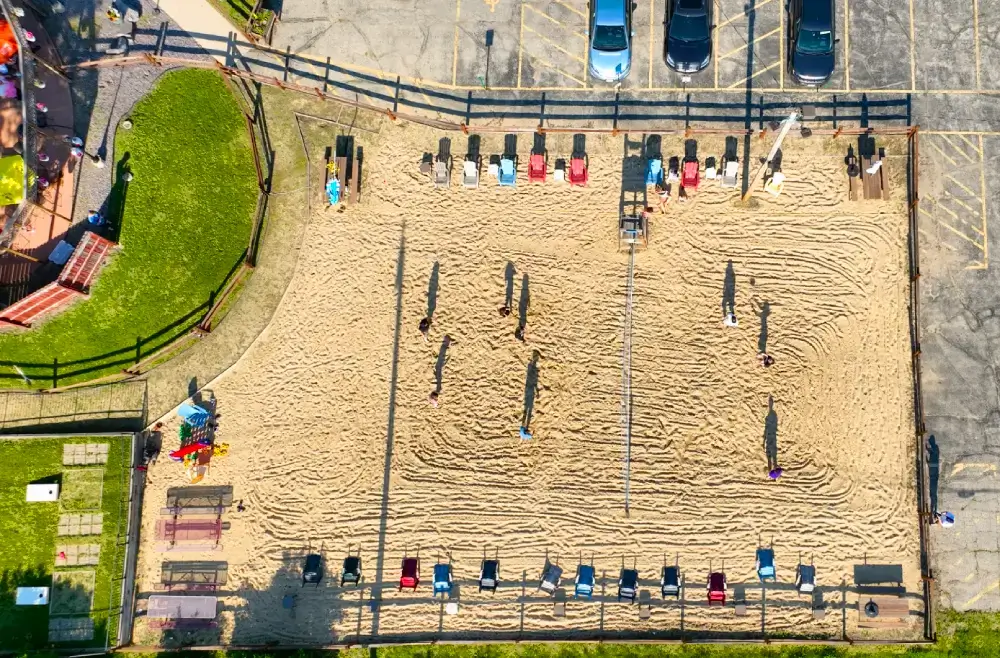 North of the Bayou Volleyball League at North of the Bayou Brewery in Madison, WI – players competing in a lively outdoor sand volleyball match with craft beer and a vibrant atmosphere.